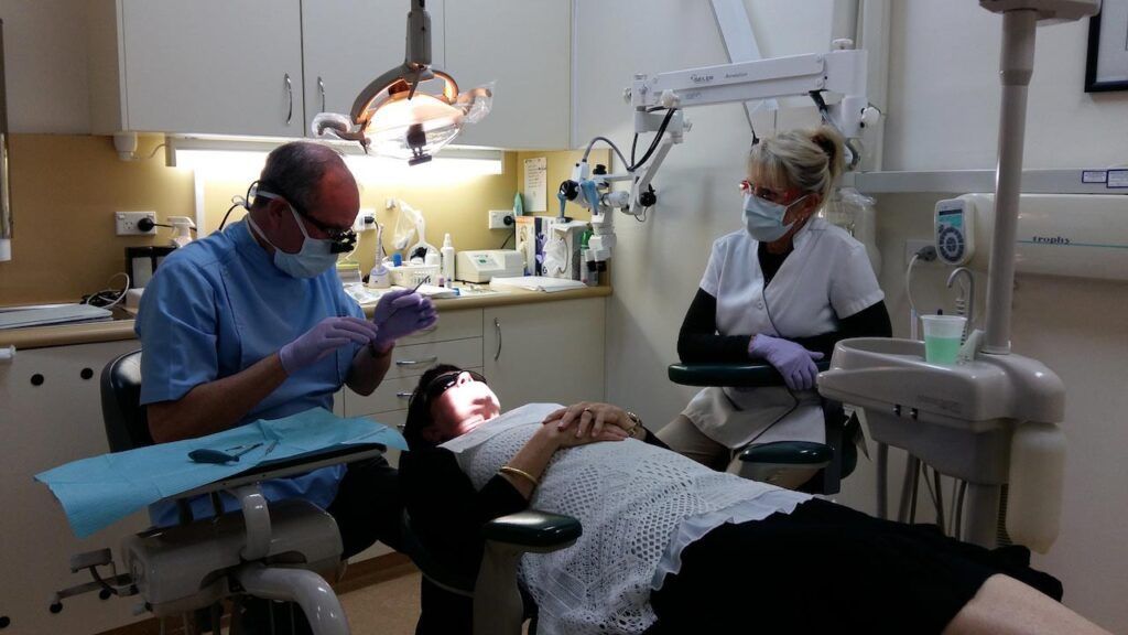 A Dentist Examines The Woman's Teeth — Advanced Dental Southern Highlands in Moss Vale, NSW