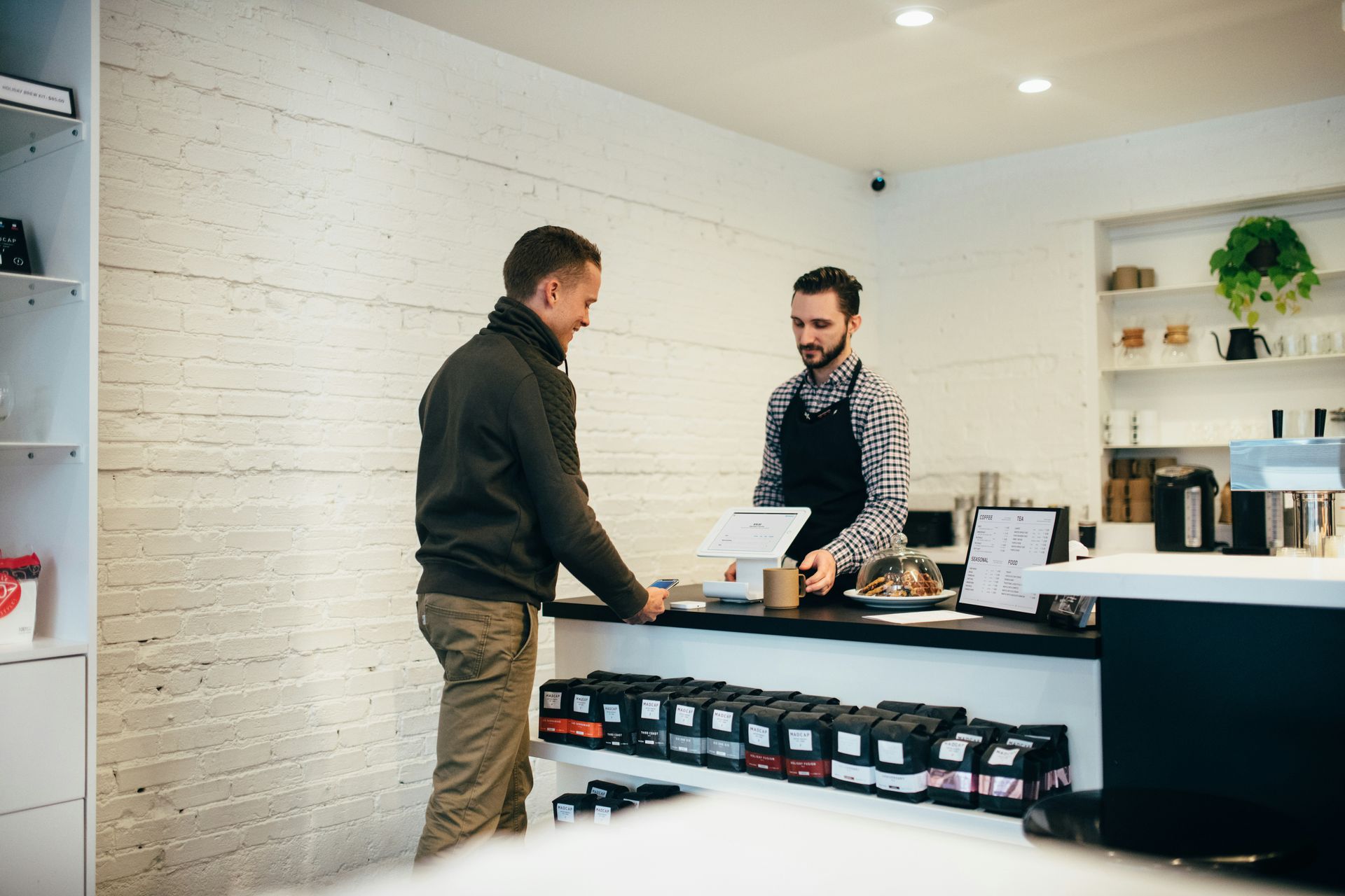 Customer purchasing coffee in a cafe