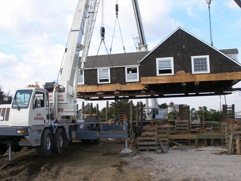 Three Cranes Setting A House On A Foundation In Westhampton