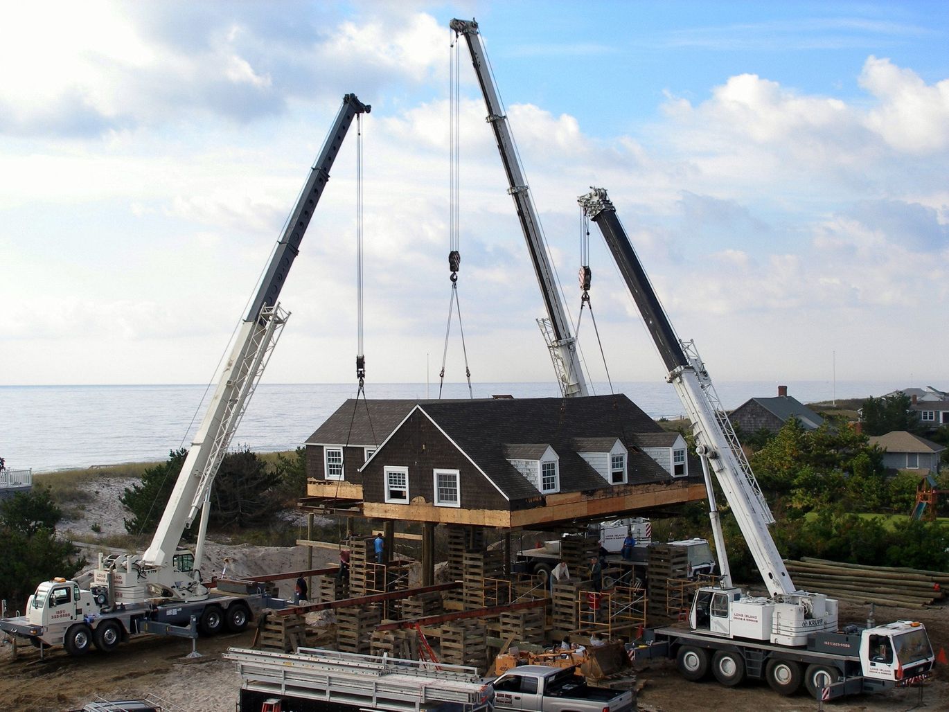 Three Cranes Setting A House Section On Its Foundation In Westhampton Beach