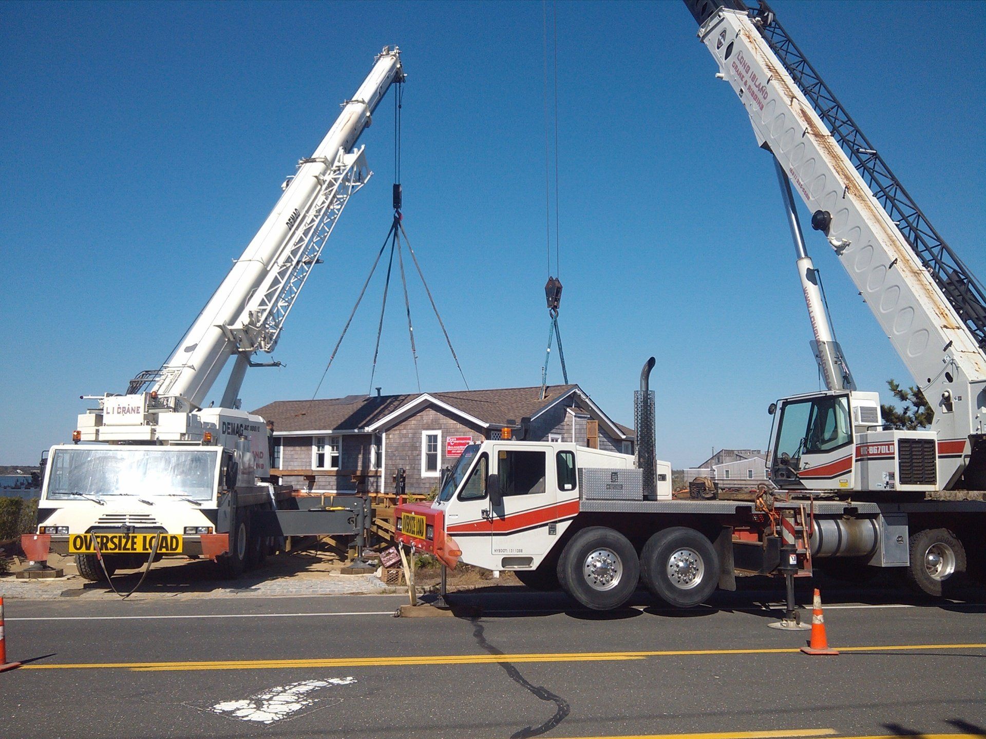 Two Cranes Setting A House On A New Foundation In Westhampton Beach