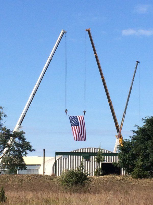 Two Cranes Holding American Flag For A Party Promotion In Calverton