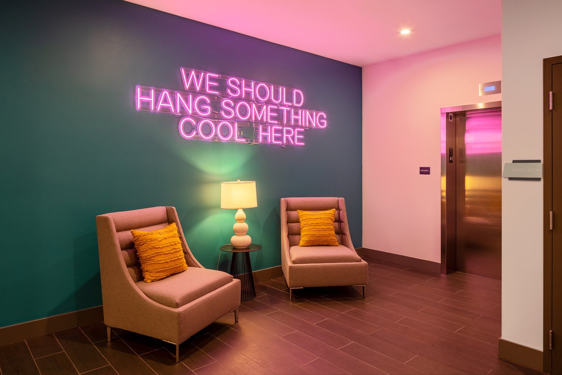 Aspire Apartment Complex Lounge With Neon Sign  Reading