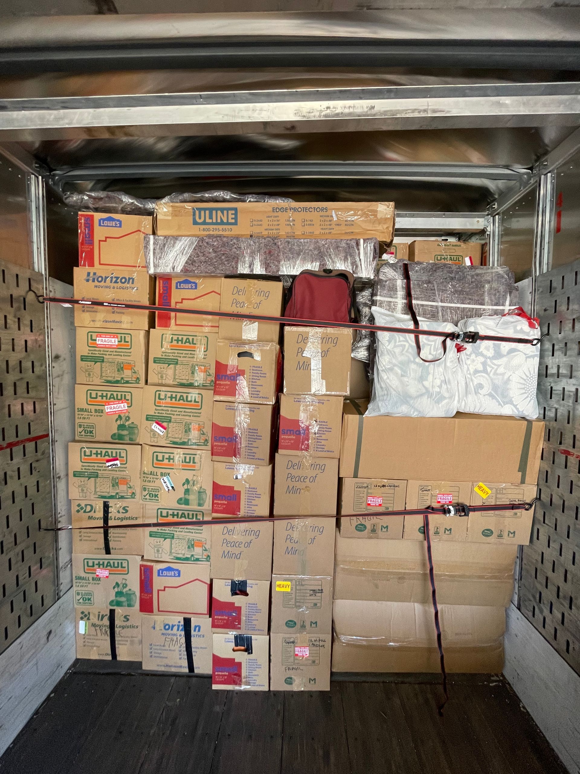 A truck filled with lots of boxes including one that says ruby