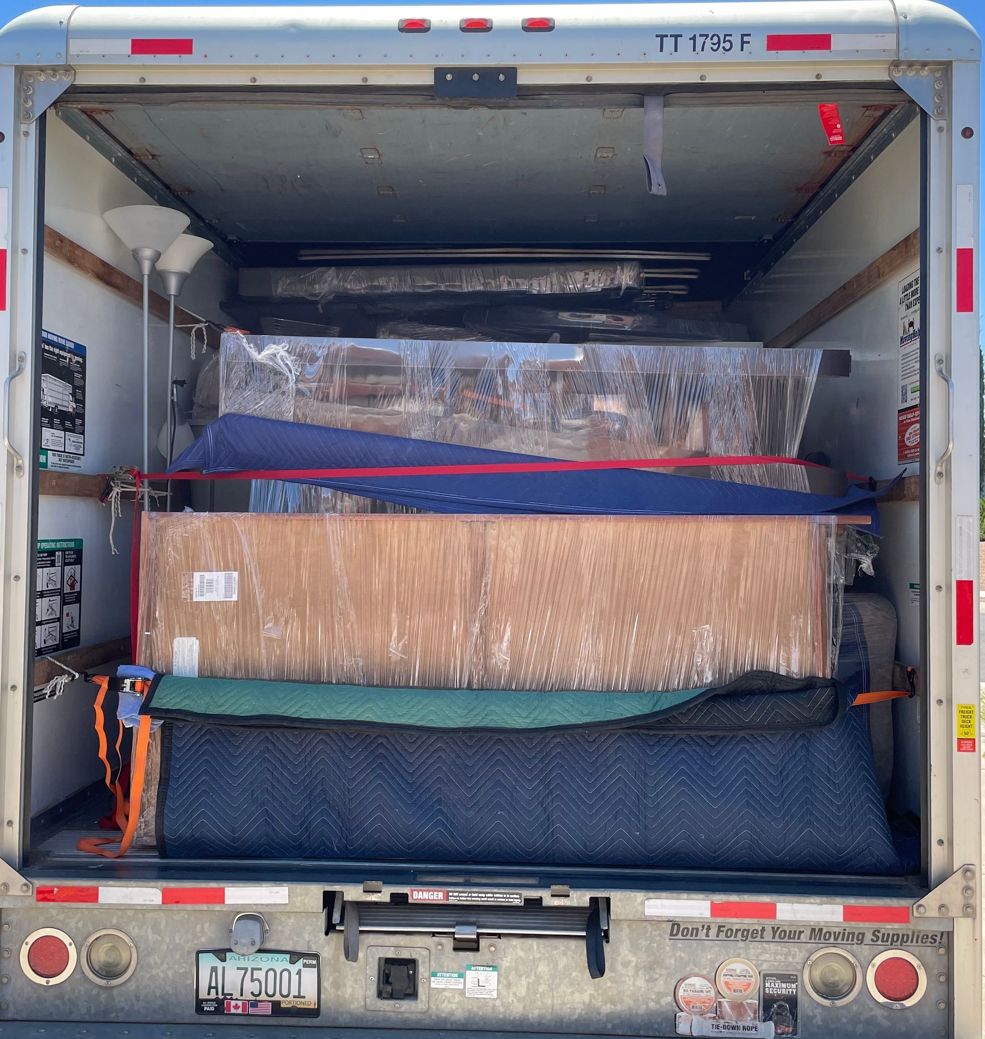 The back of a moving truck with a license plate that says big south