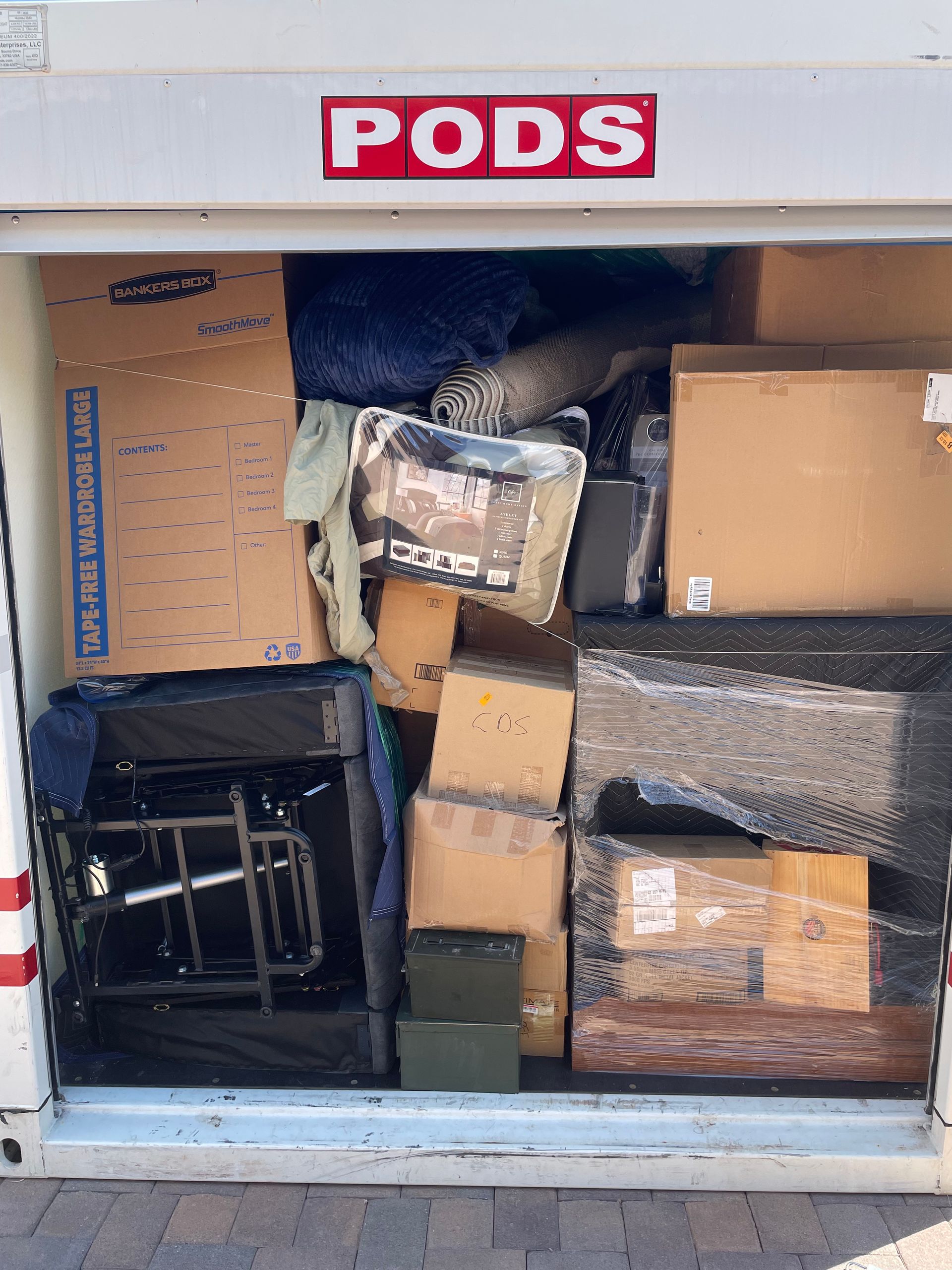 A pods container filled with boxes and a wheelchair