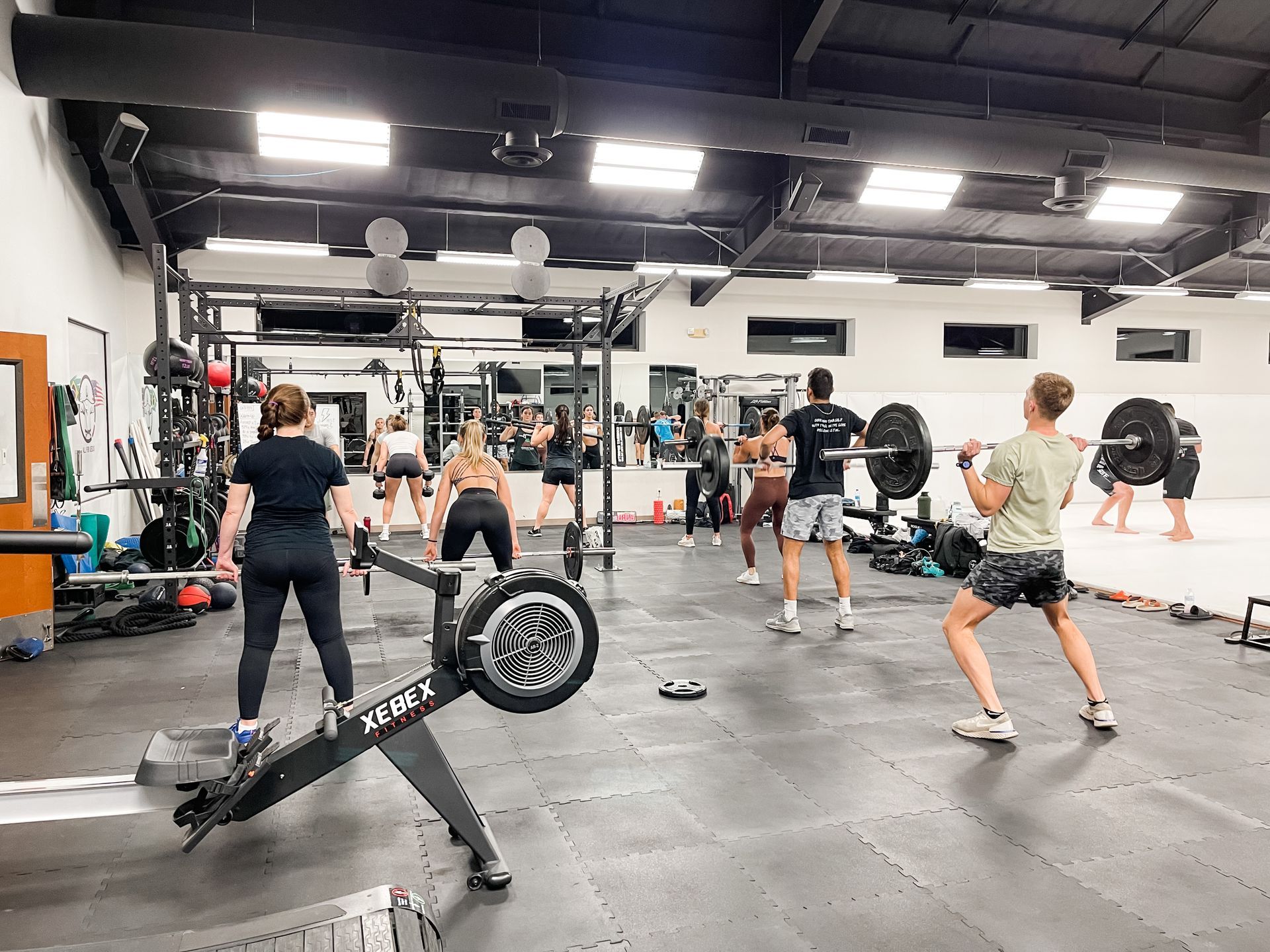 A group of people are doing exercises in a gym.