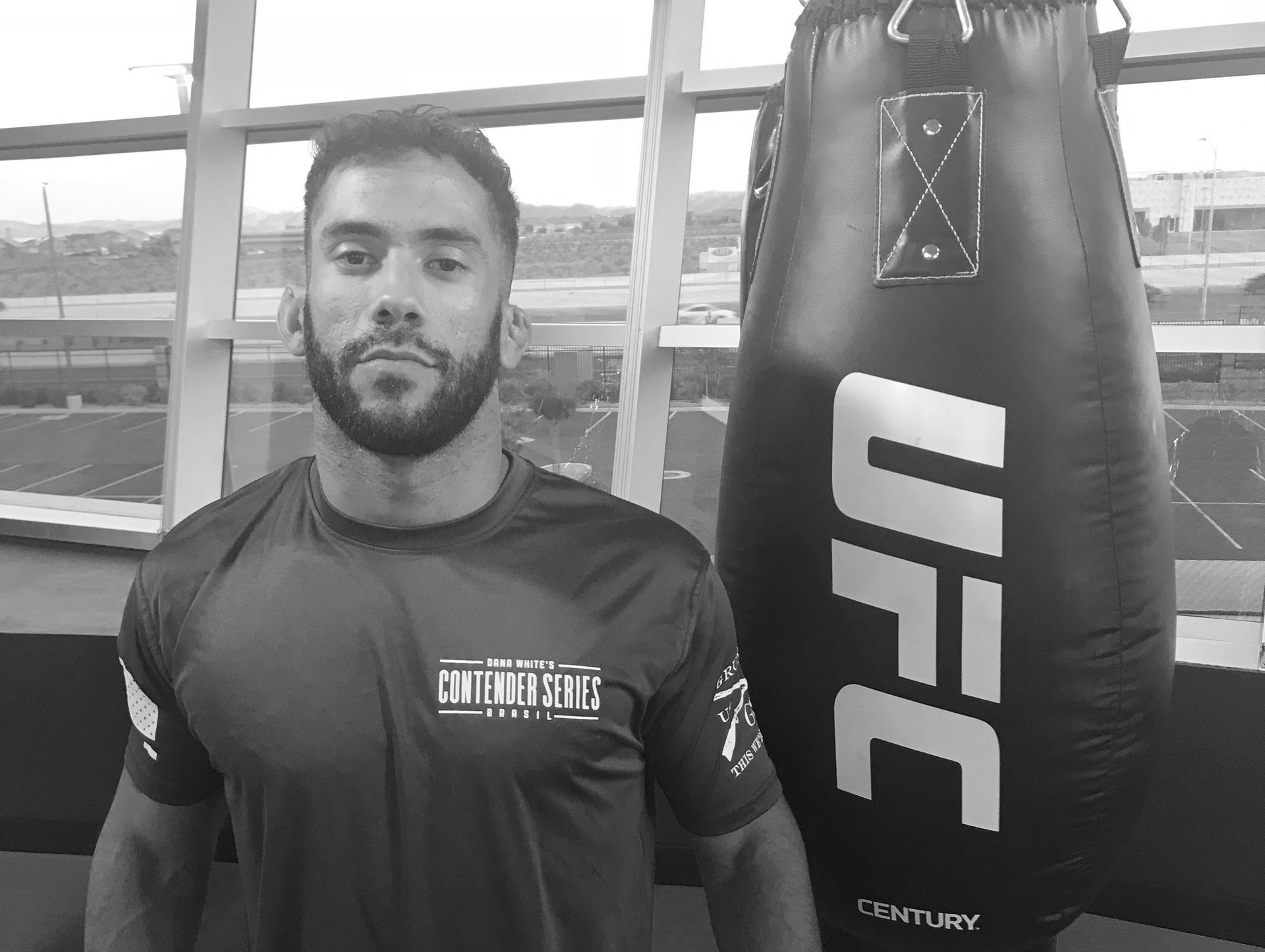 A black and white photo of a gym with a lot of equipment.