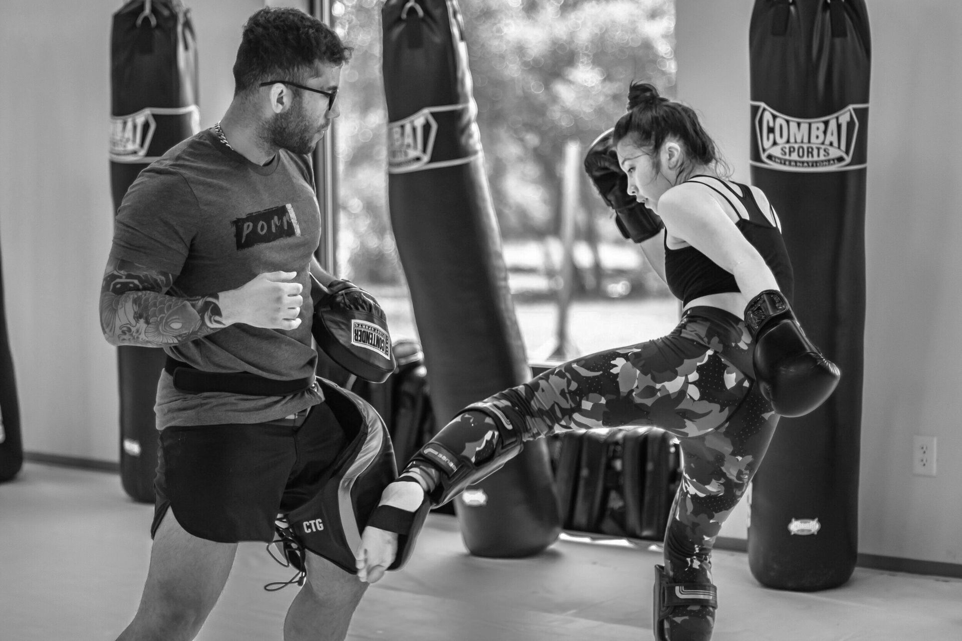A man with a beard wearing boxing gloves.