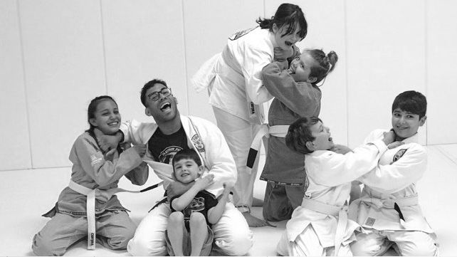 A group of people in karate uniforms are posing for a picture.