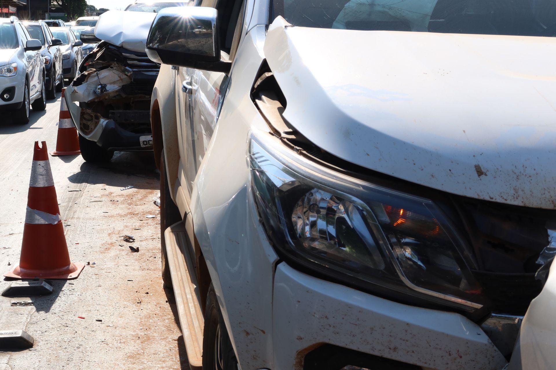 A white car has been damaged in a traffic accident.