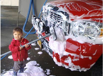 Child showing how easy it is to use the car wash