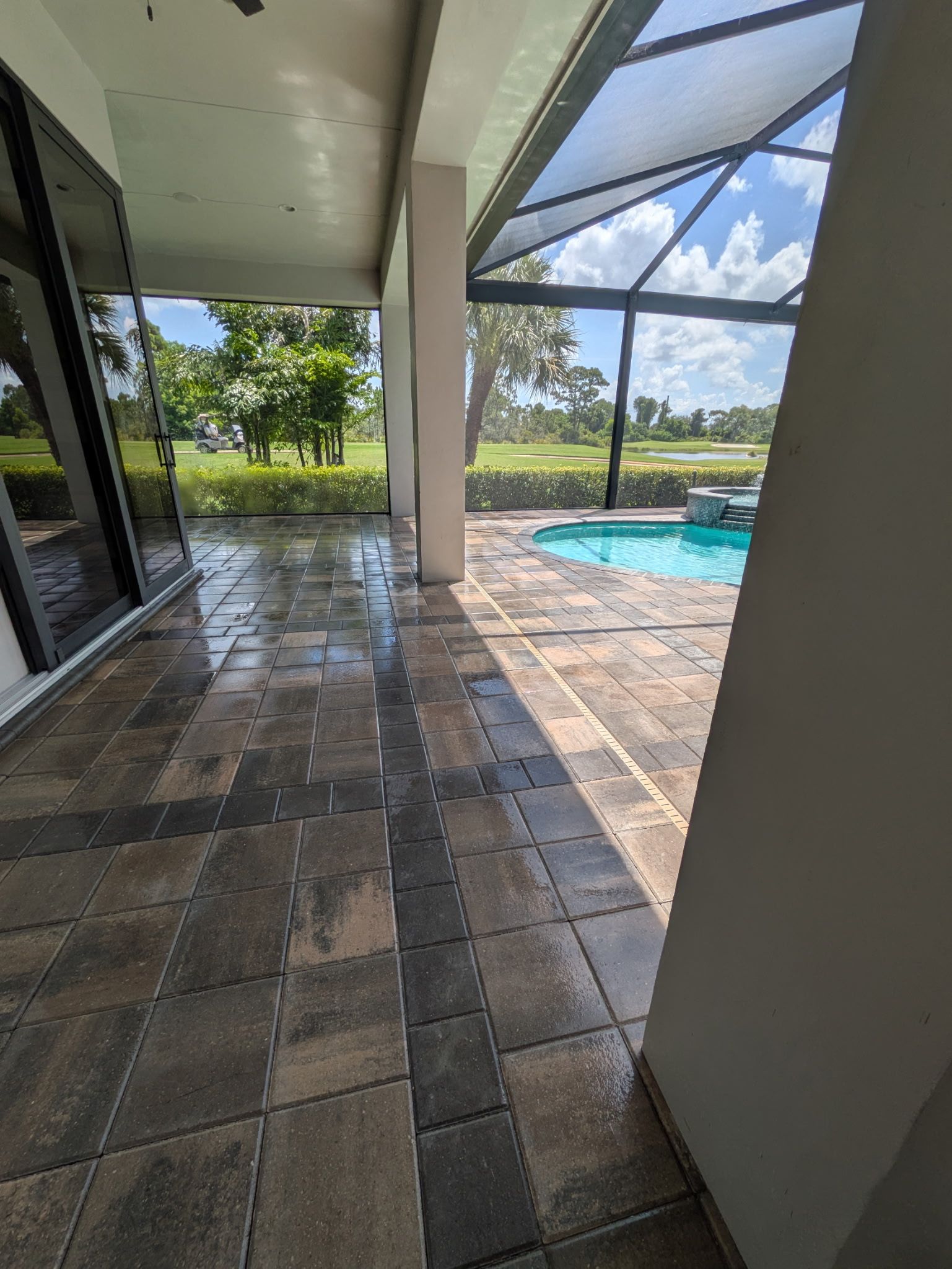 Brick paving in a herringbone pattern, various shades of tan and brown.