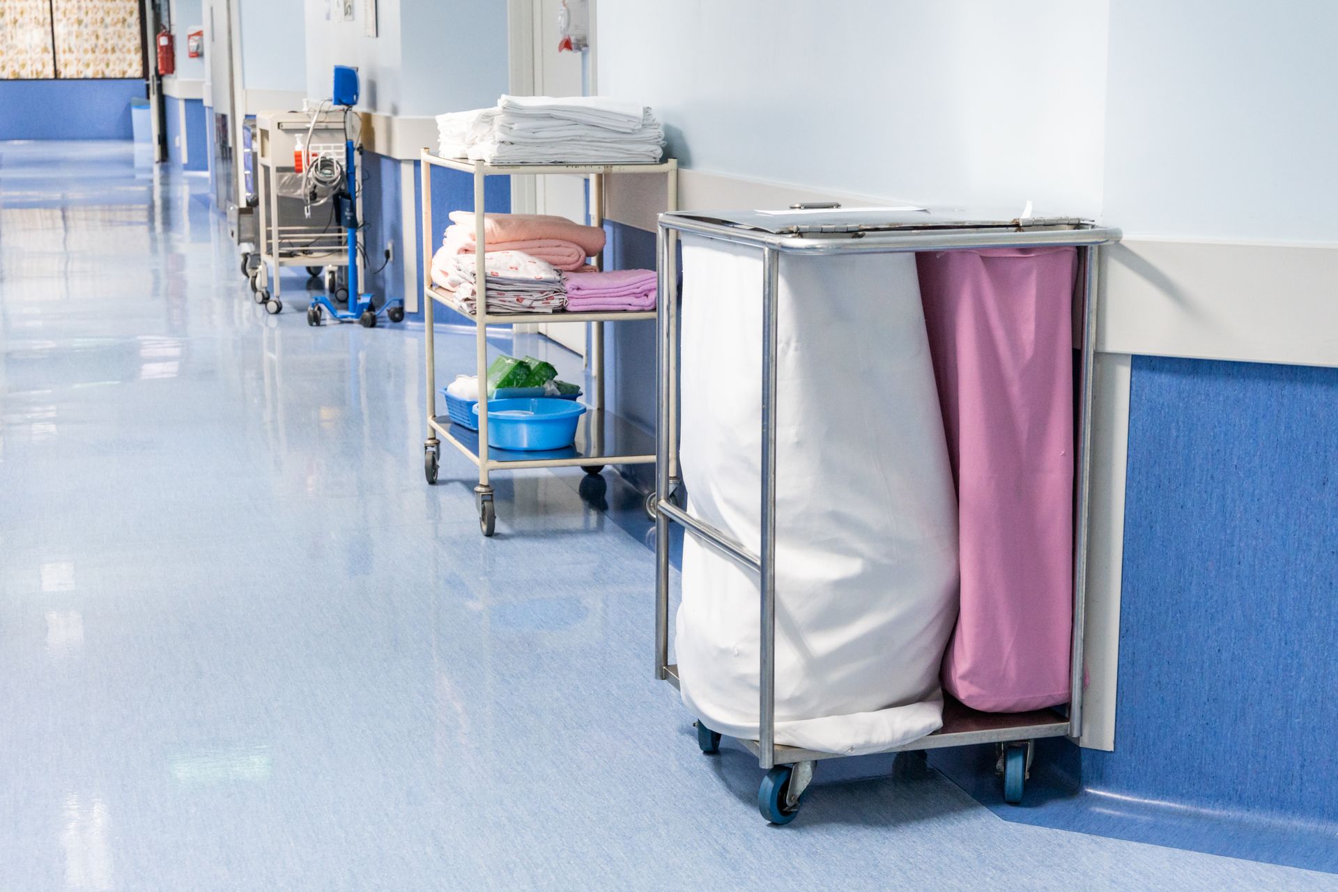 A row of laundry carts in a hospital hallway