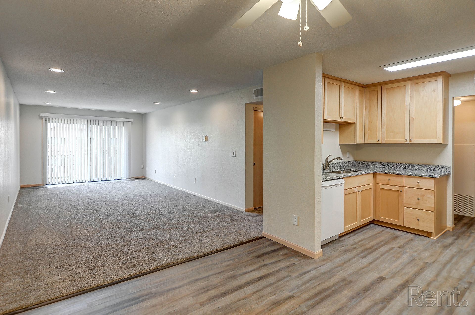 there is a ceiling fan in the living room and a kitchen .