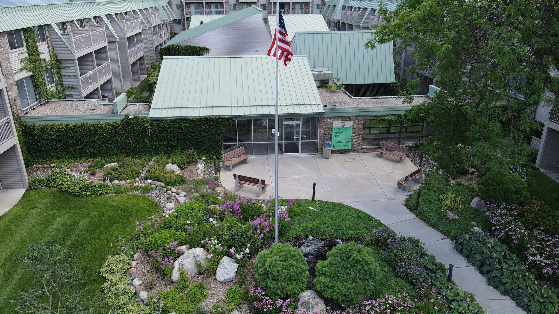 an aerial view of a building with a flag flying in front of it .