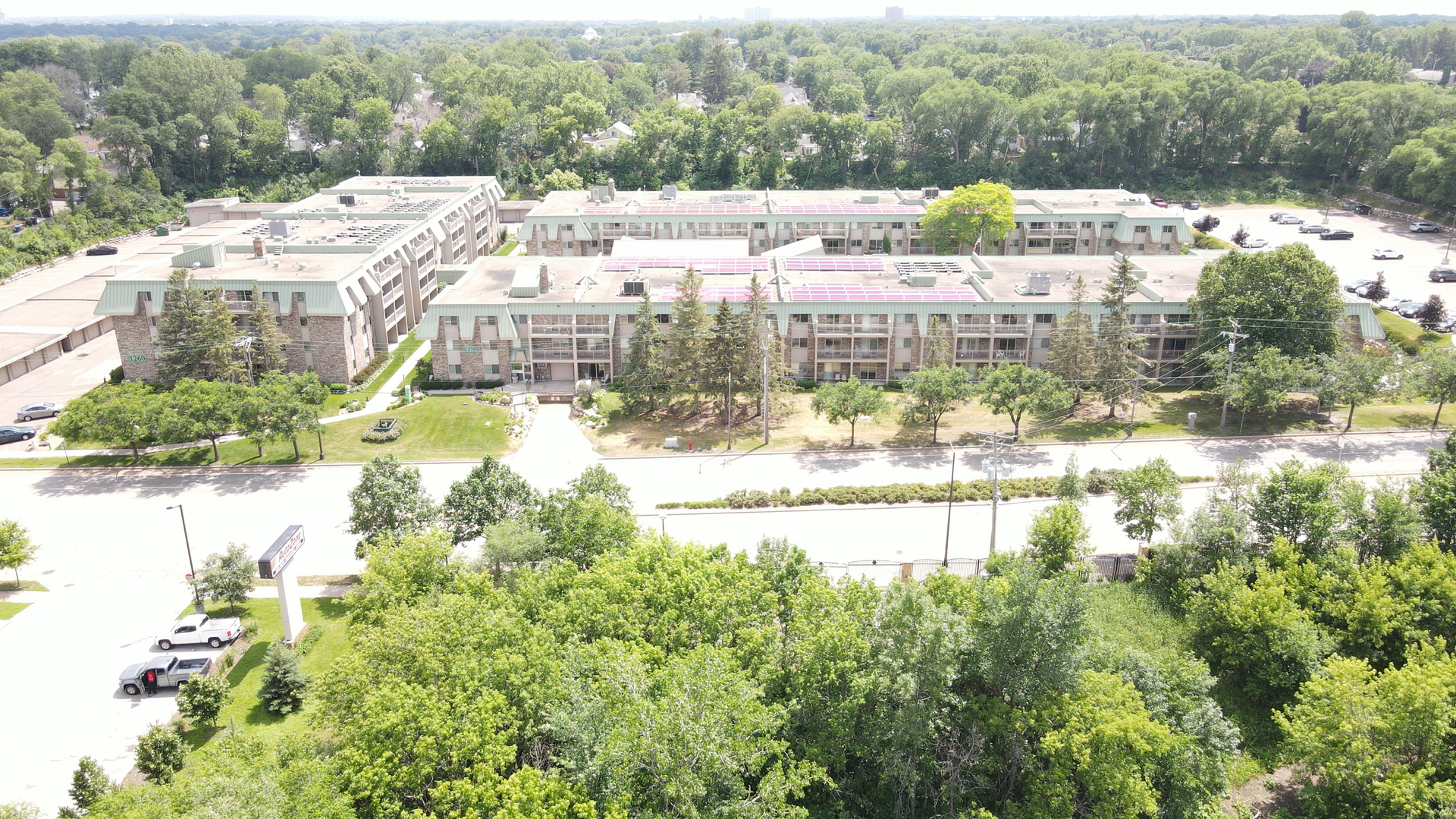 an aerial view of a large building surrounded by trees