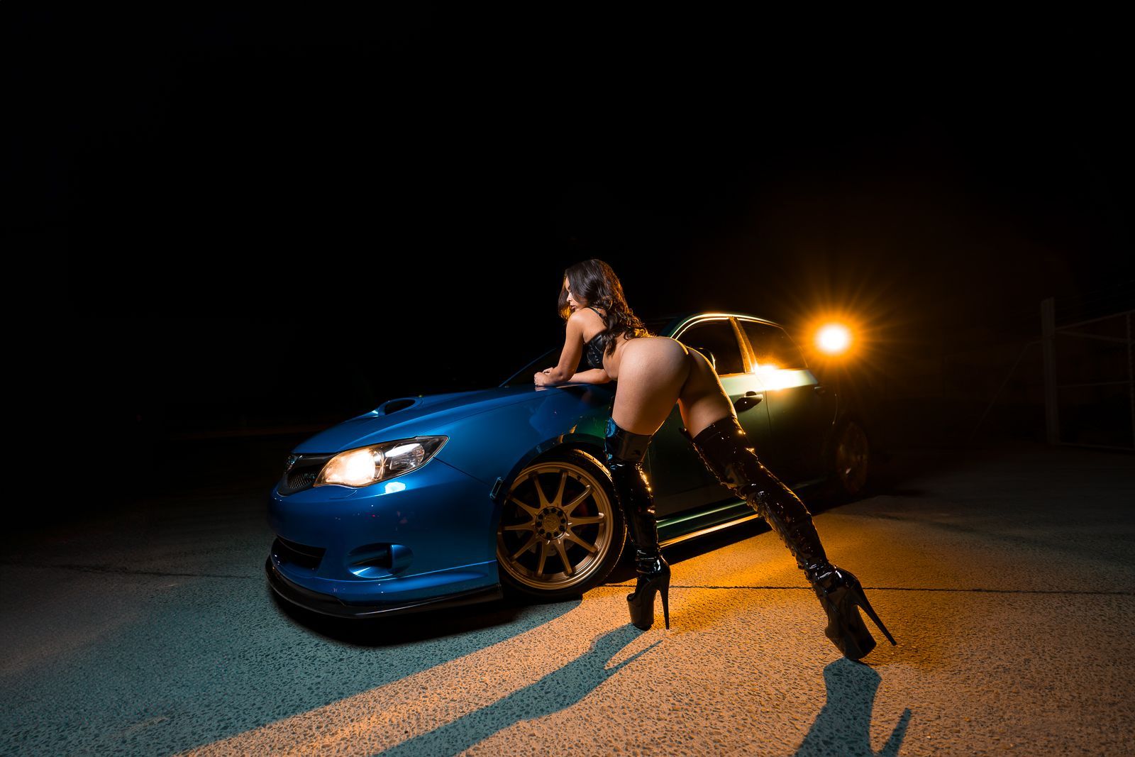Glamorous Brisbane stripper posing with luxury car for premium party entertainment.