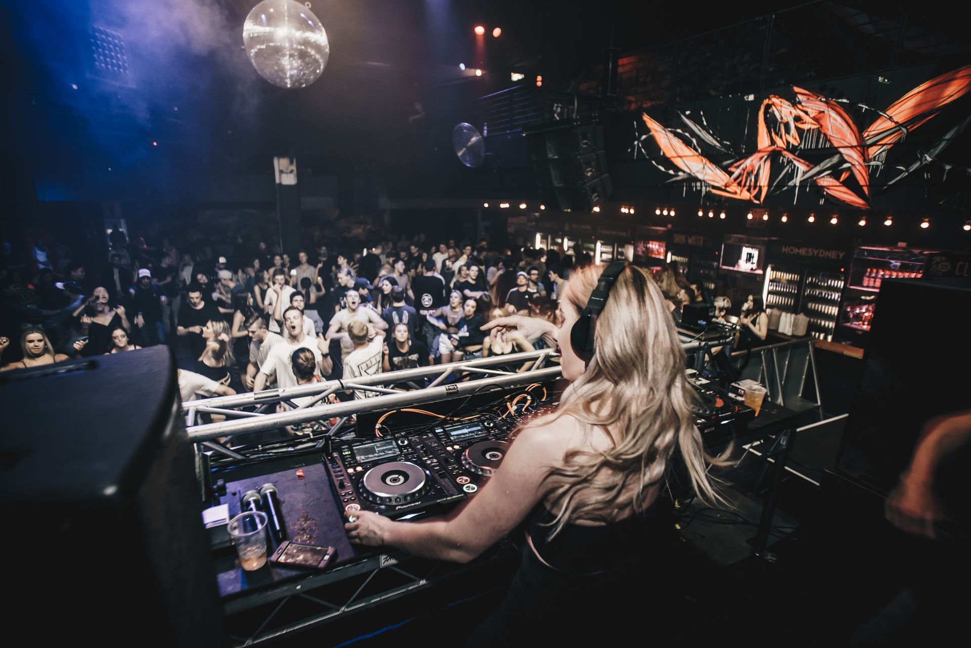 A Woman Is Playing Music At A Party In A Club