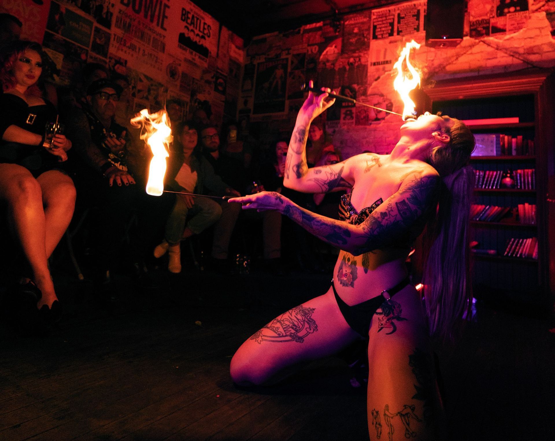 Tattooed woman eating fire.