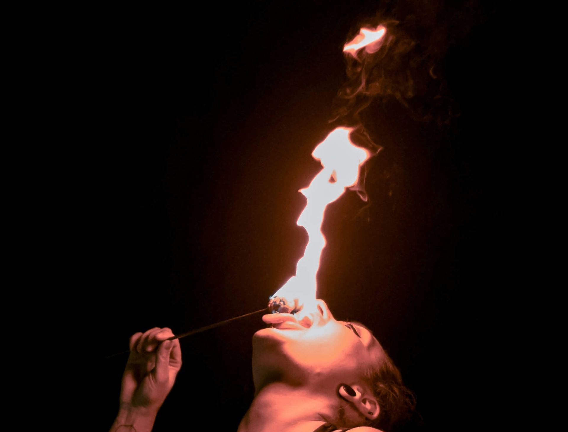 Woman eating fire.