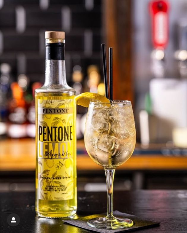 A bottle of Aperitivo Pentone Lemon with a signature spritz serve with Prosecco and soda