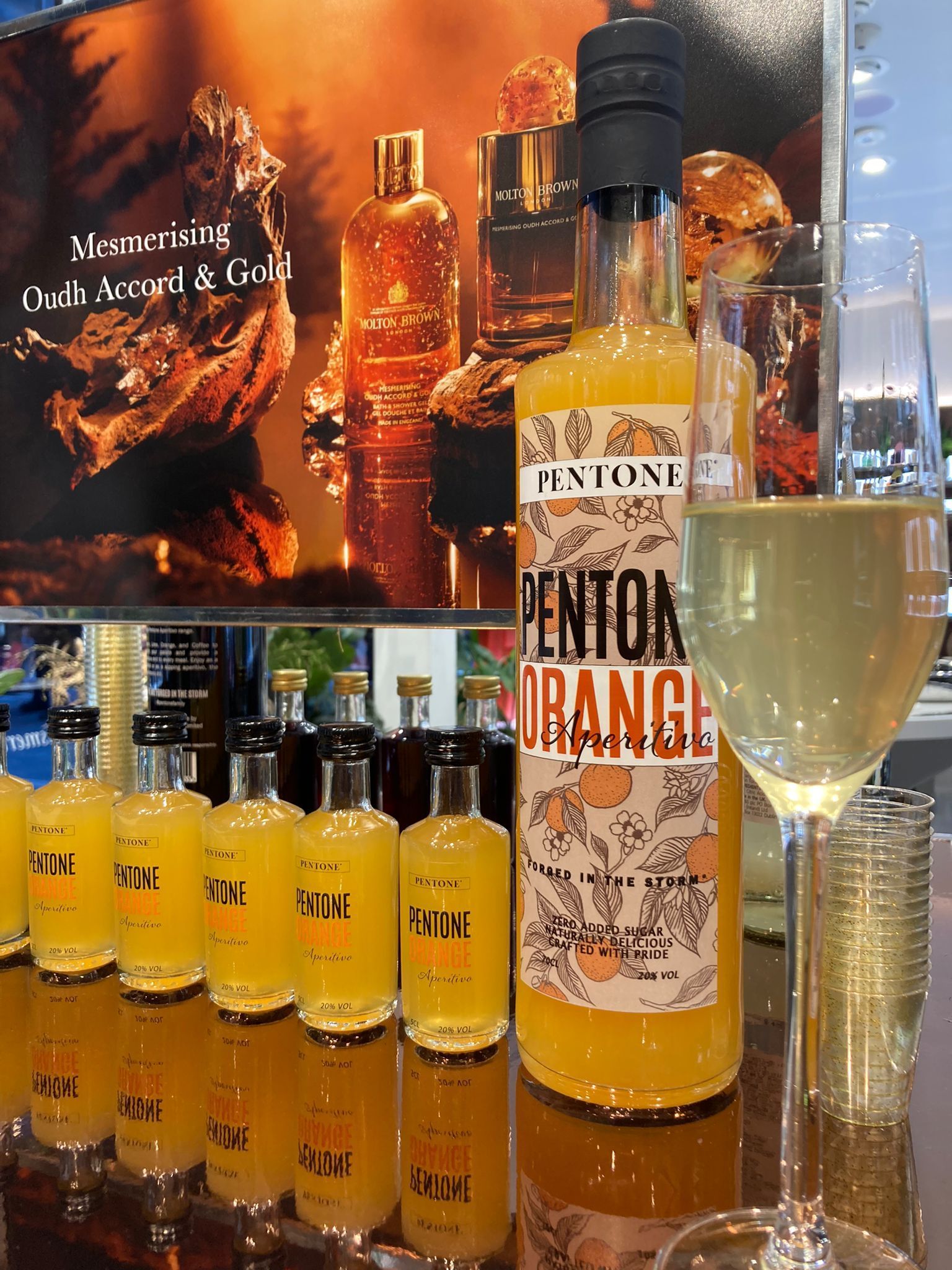 A bottle of pentone orange liqueur is sitting on a white surface.