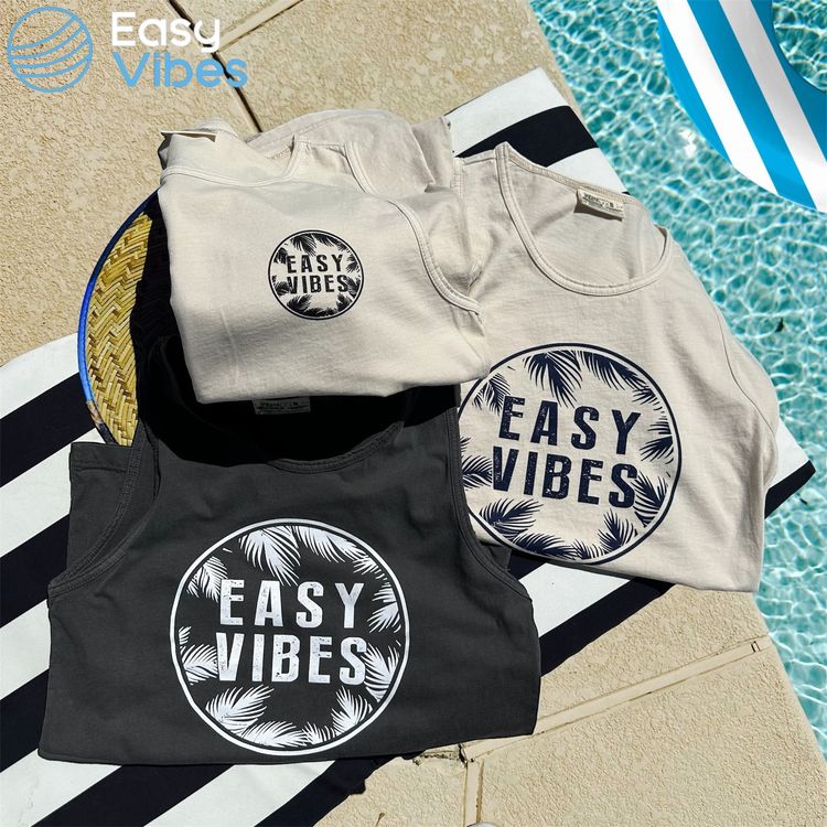 three Easy Vibes shirts aesthetically placed next to a clean bright inviting swimming pool