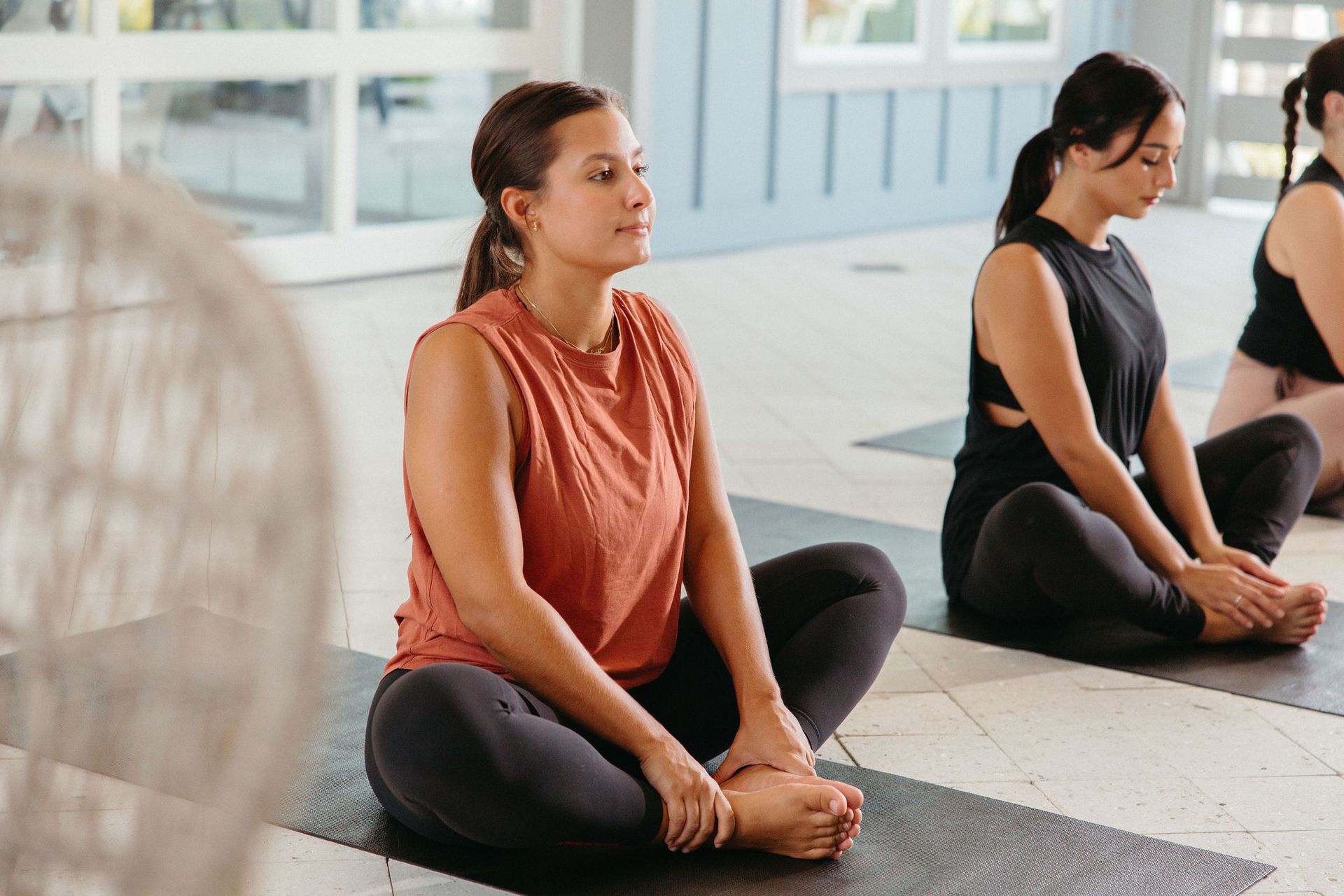 A woman is sitting on a yoga mat at Livano Wildwood