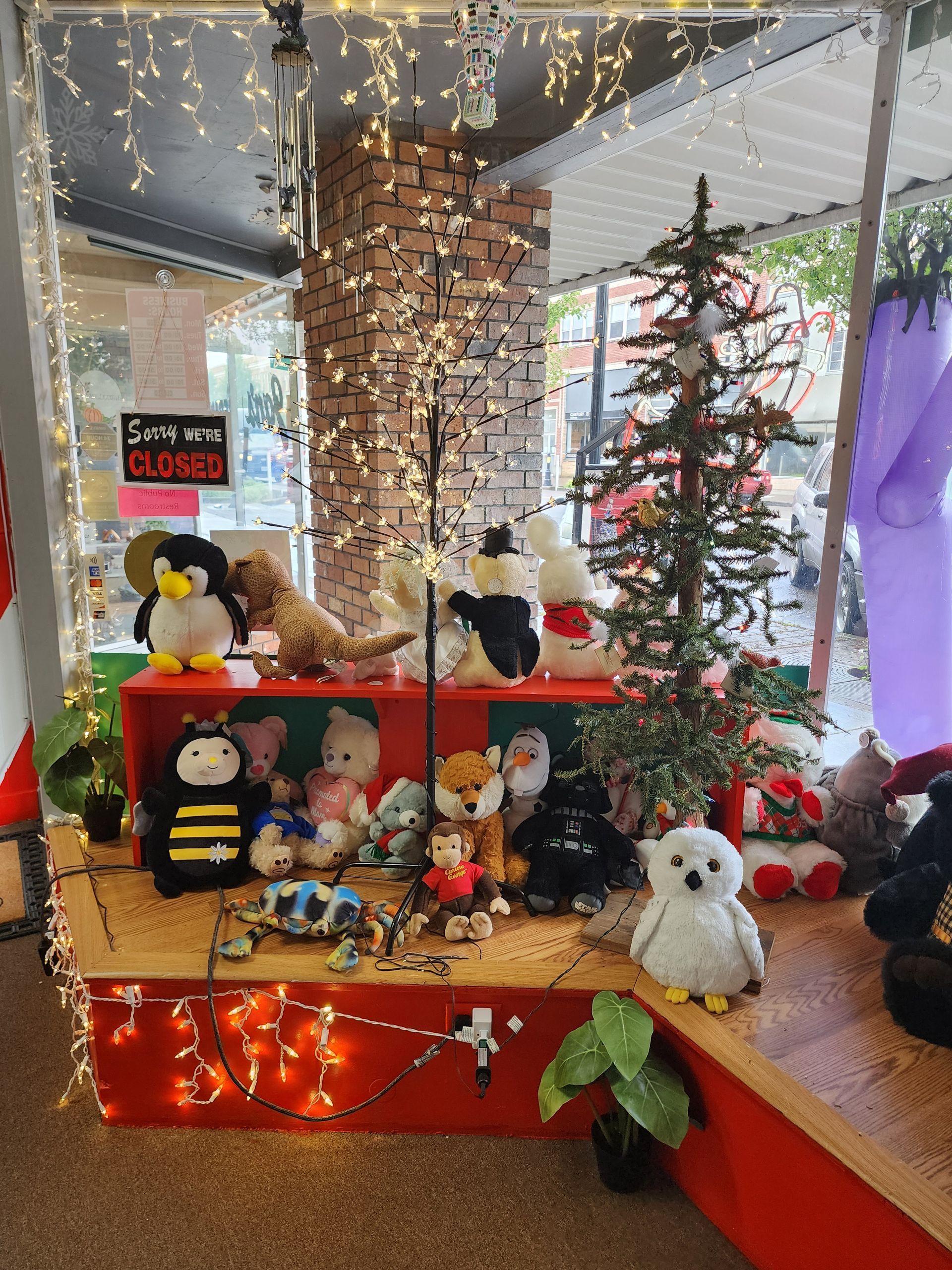 A room filled with stuffed animals and a christmas tree.