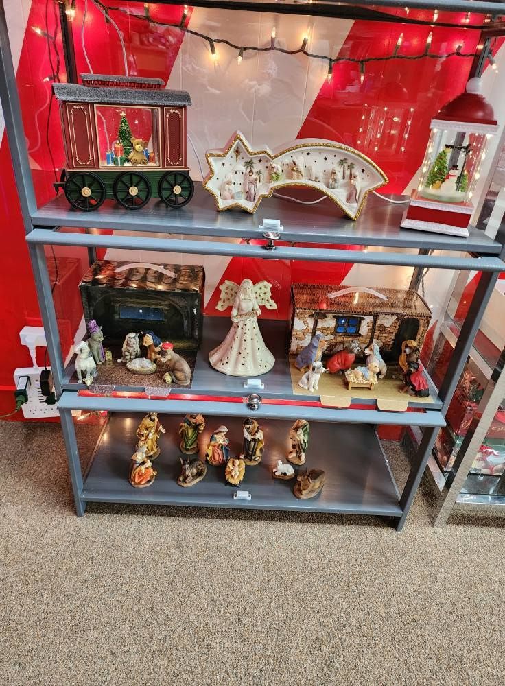 A shelf with a lot of christmas decorations on it.