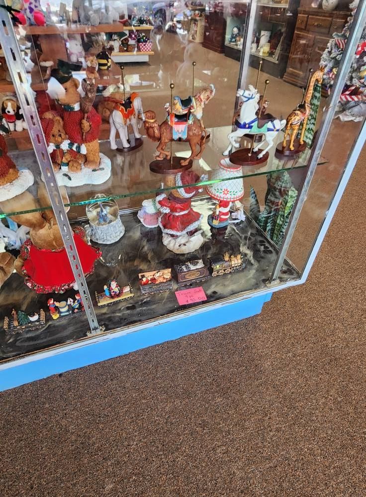 A display case filled with lots of christmas decorations in a store.