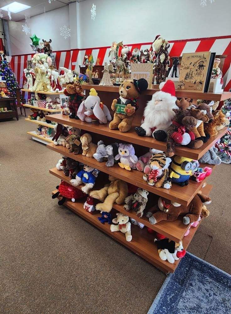 A shelf filled with lots of stuffed animals in a store.