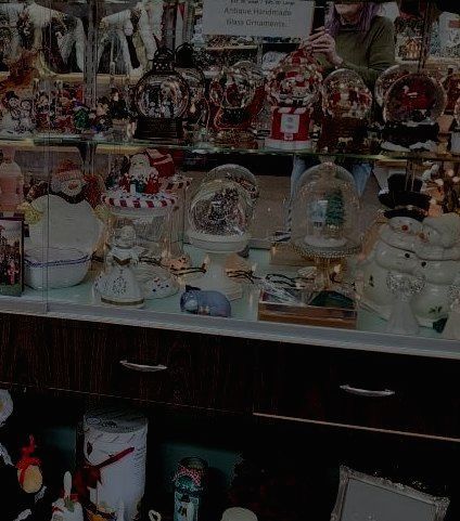 A display case filled with lots of christmas decorations and snow globes.