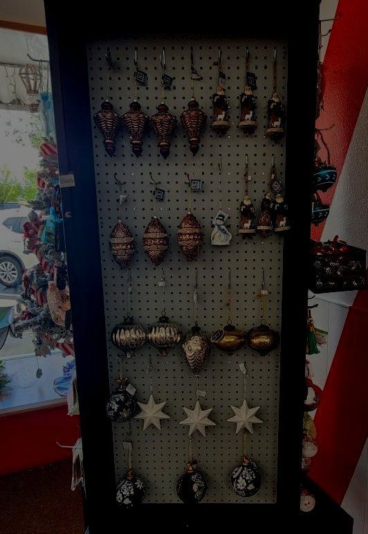 A display of christmas ornaments on a peg board