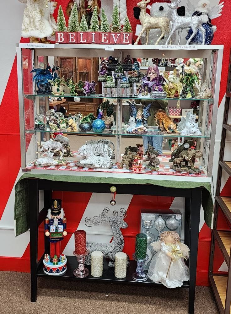 A display case filled with christmas decorations and a sign that says believe.