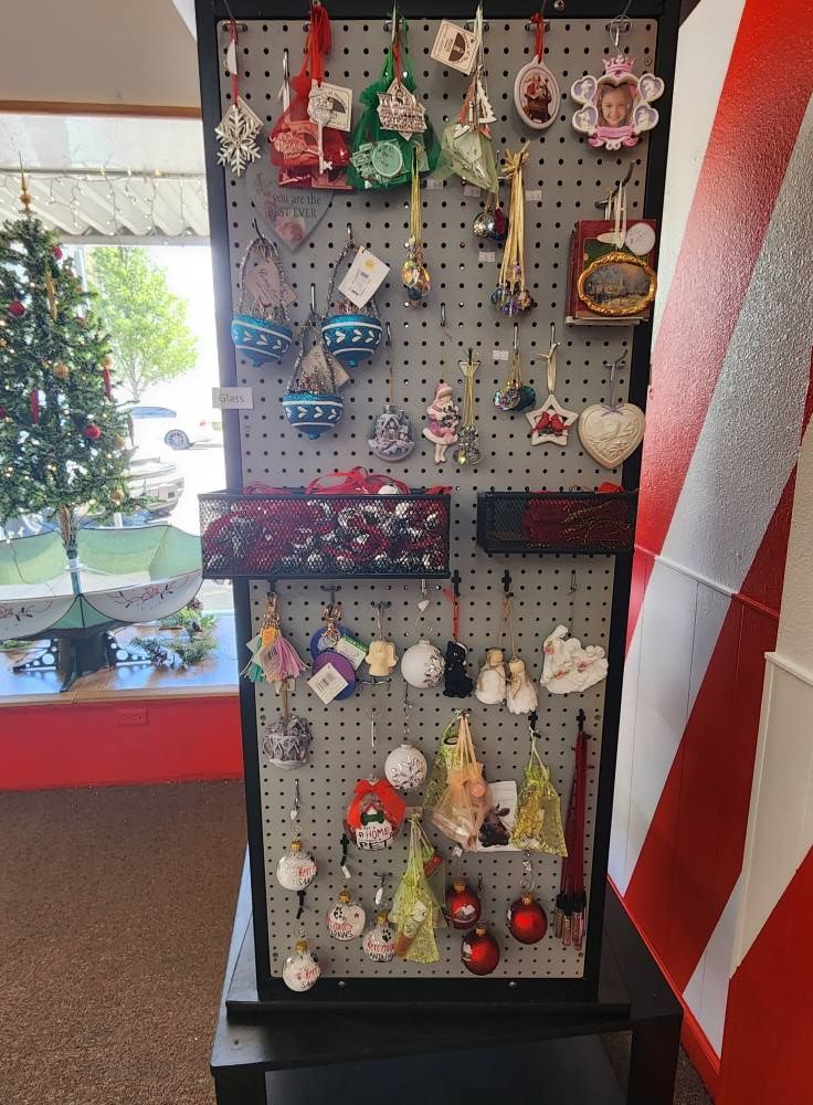 A display of christmas ornaments in front of a christmas tree