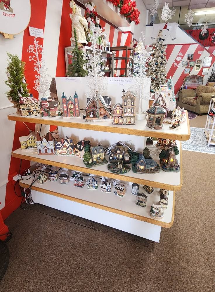 A display of christmas decorations on shelves in a store
