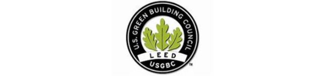 Circular black-and-green LEED certification logo with a leaf and building icon in the center