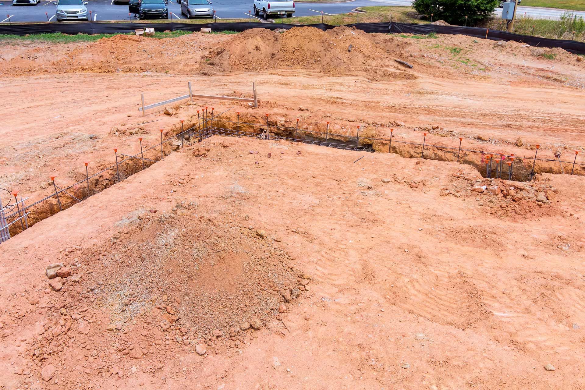 A large pile of dirt is sitting on top of a dirt field.