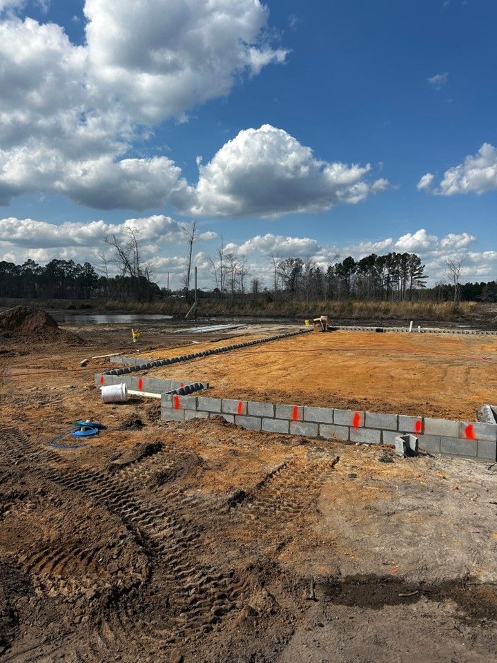 A construction site with a blue sky and clouds in the background.