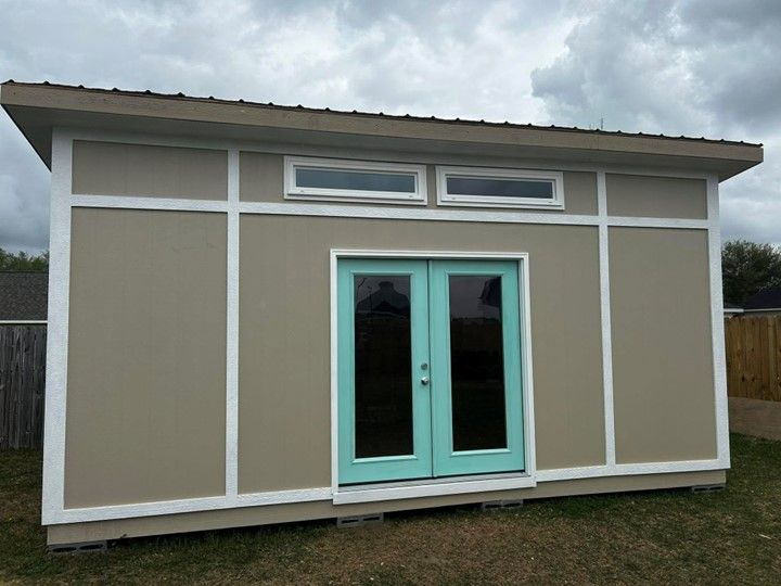 A shed with a blue door and two windows