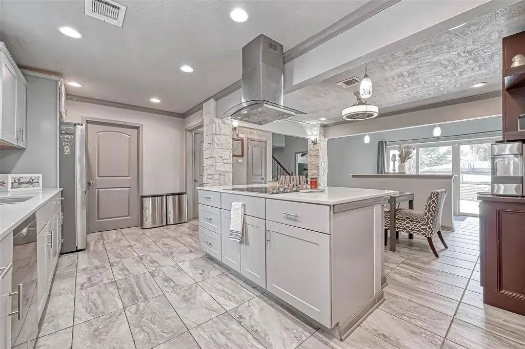 a bathroom with two sinks and a skylight
