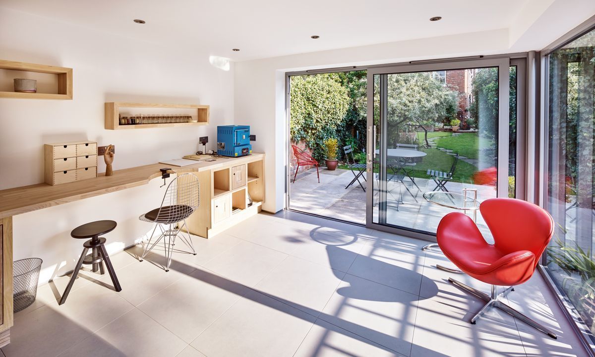 an empty room with wooden floors and a large window .