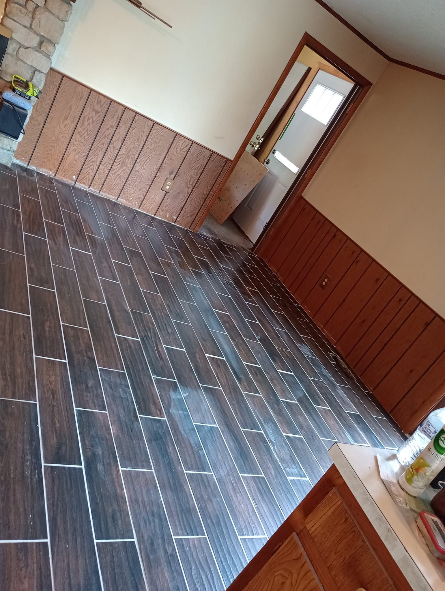 A room with a wooden floor and a door.