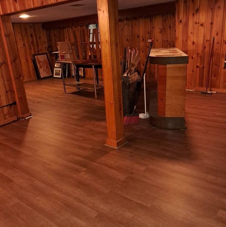 A room with wood paneling and a wooden floor.