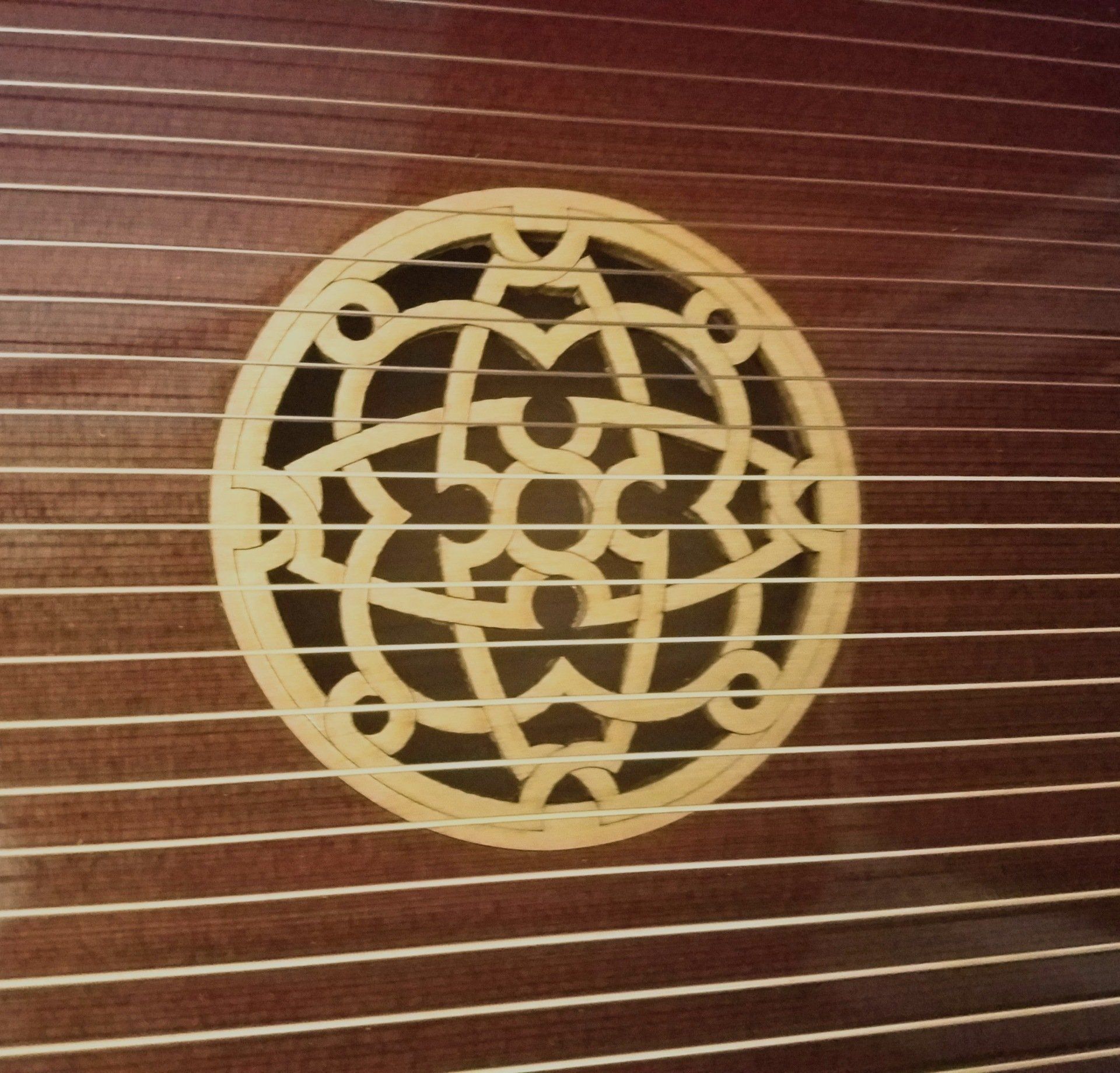 A wooden harp with a circular design on it