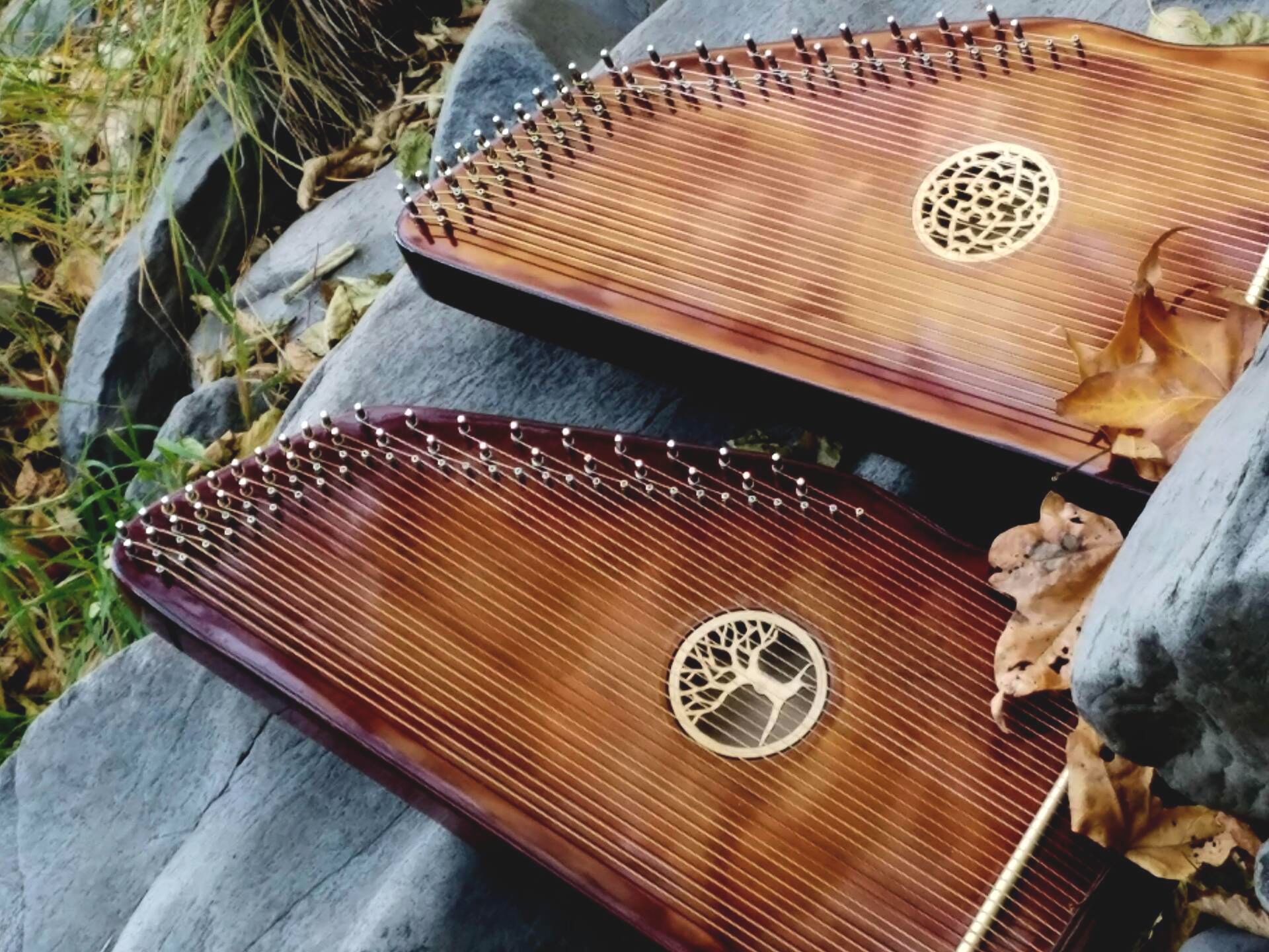 Two harps with a tree of life design on them