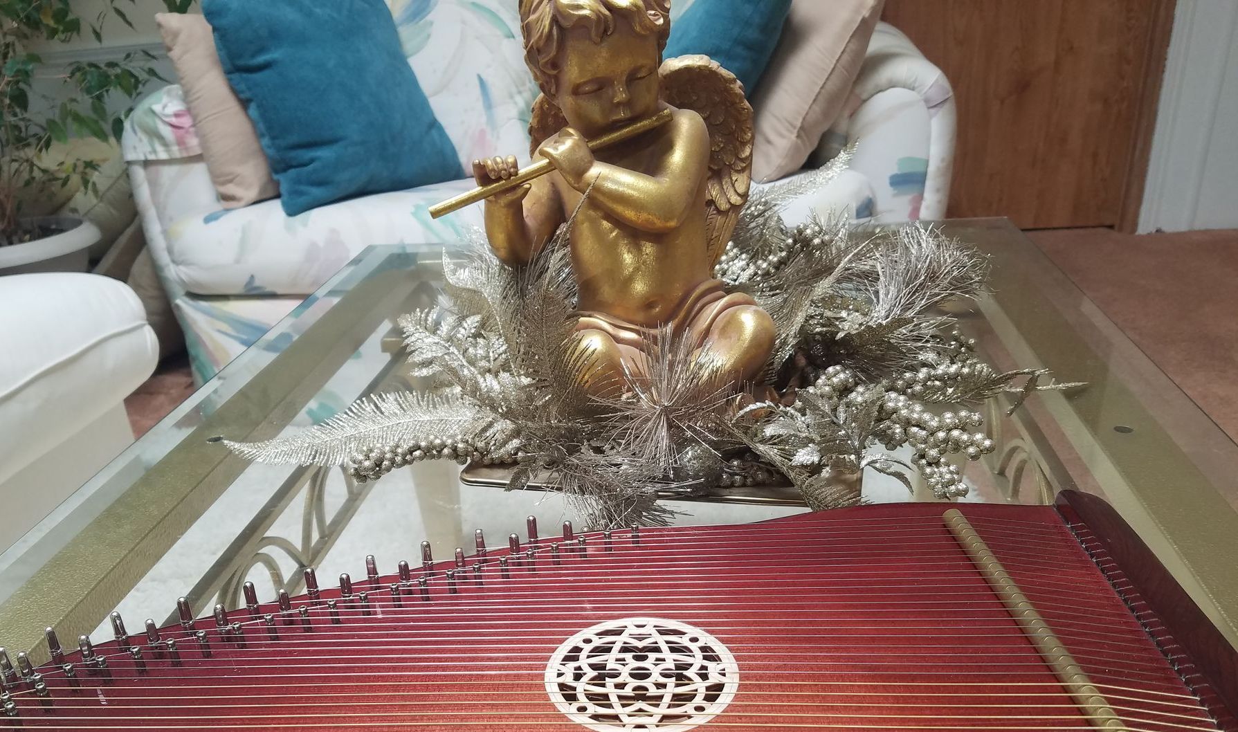 A table with a harp and a statue of an angel on it