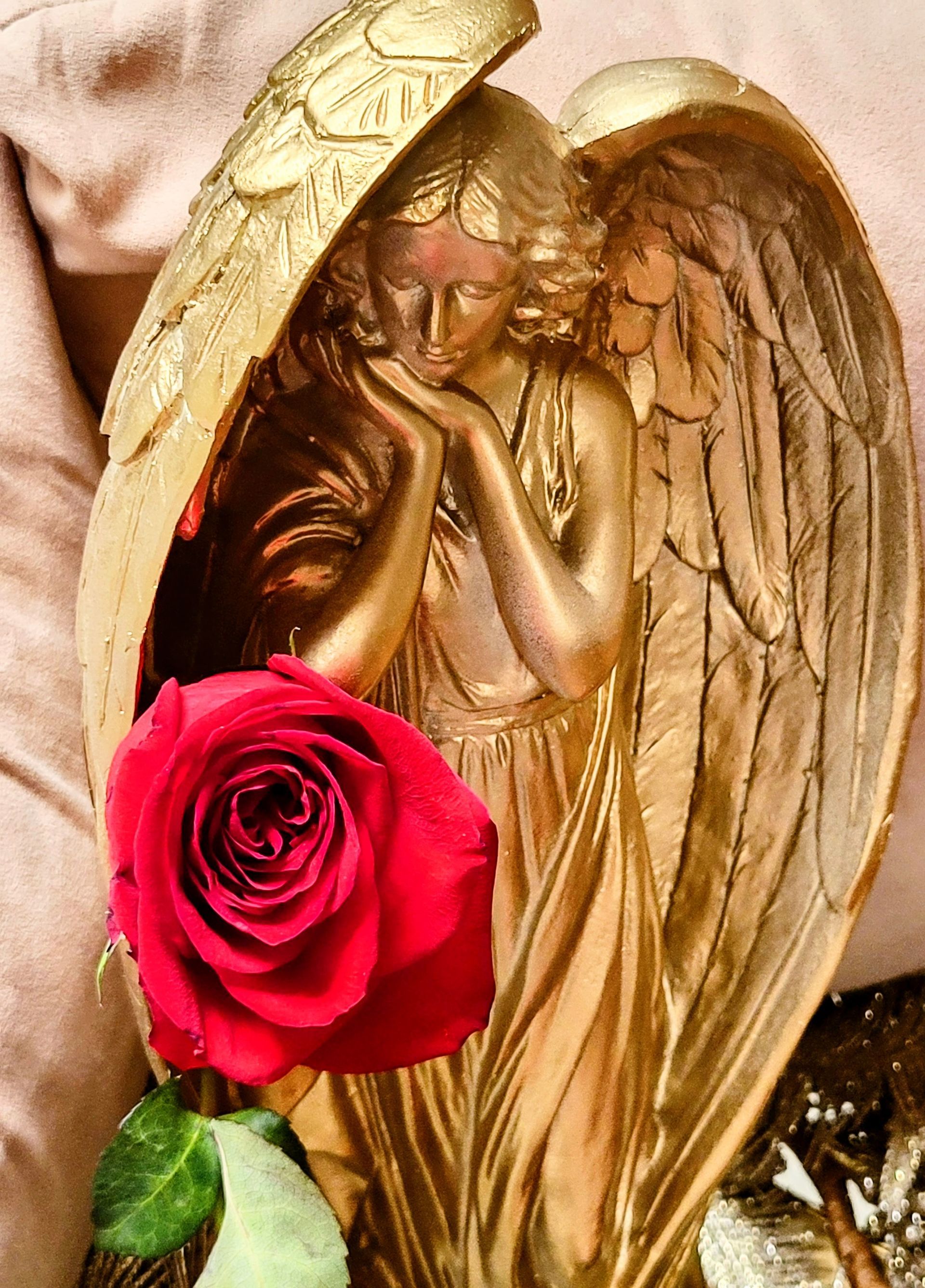 A harp is sitting next to a statue of an angel.